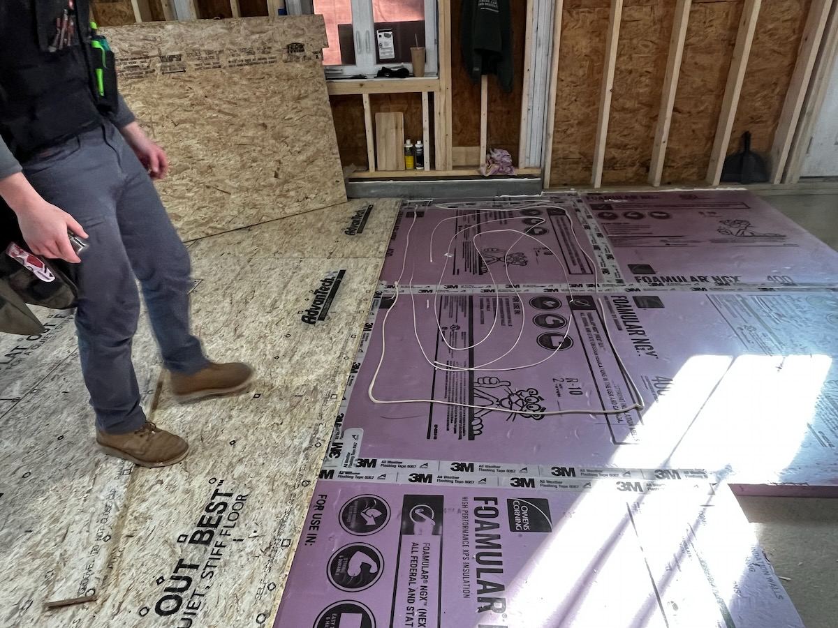 Rigid foam floor insulation installed over subfloor